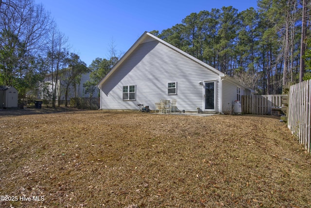 rear view of house featuring a lawn