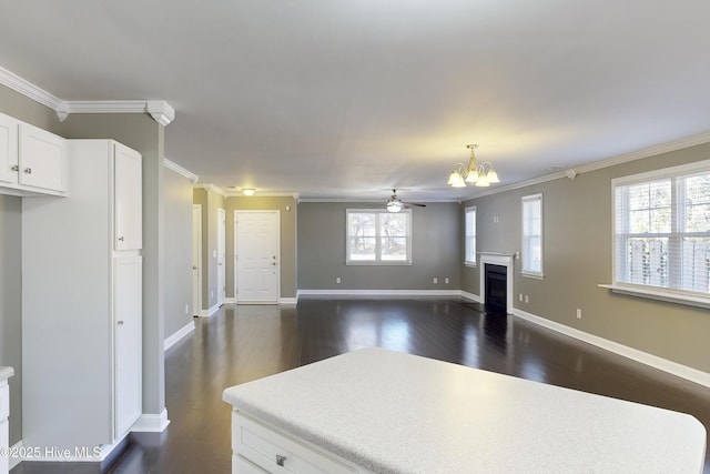 kitchen featuring white cabinetry, ornamental molding, and dark hardwood / wood-style floors