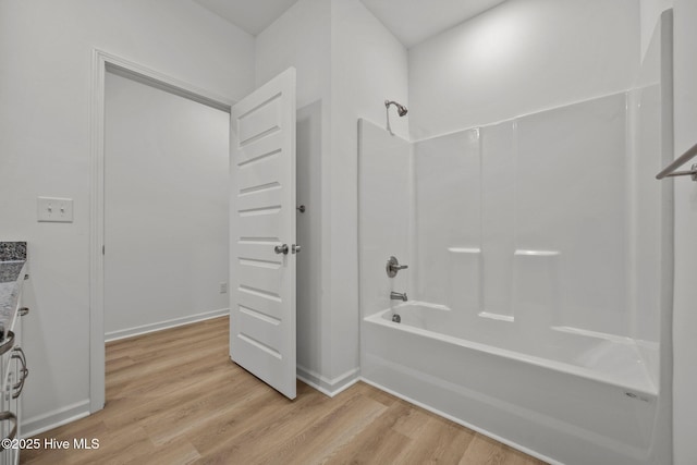 bathroom featuring hardwood / wood-style floors and shower / bathing tub combination