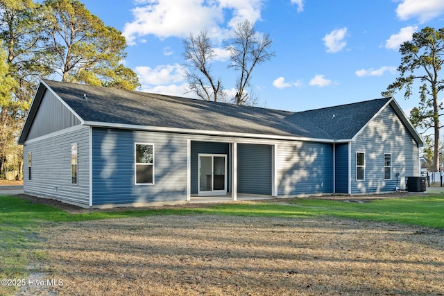 back of house featuring a yard and central AC