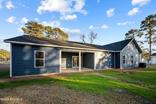 back of property featuring a yard, a patio, and central air condition unit