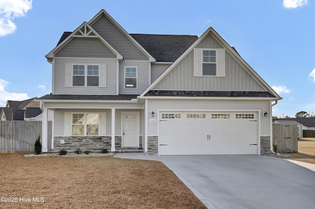 craftsman inspired home with a garage and a front yard