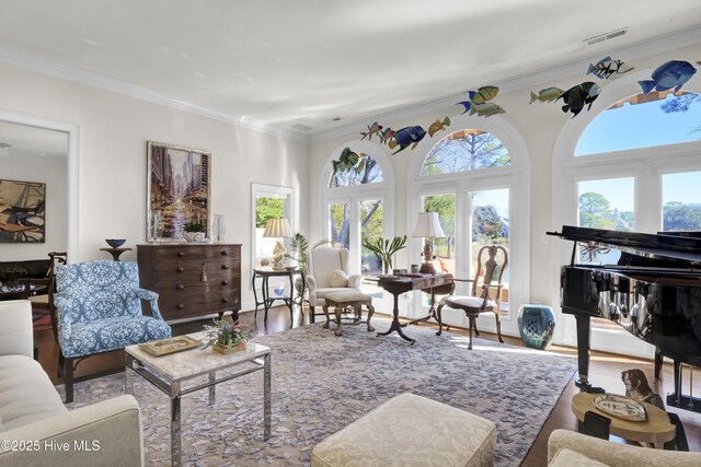 living room with an inviting chandelier, ornamental molding, and dark hardwood / wood-style floors