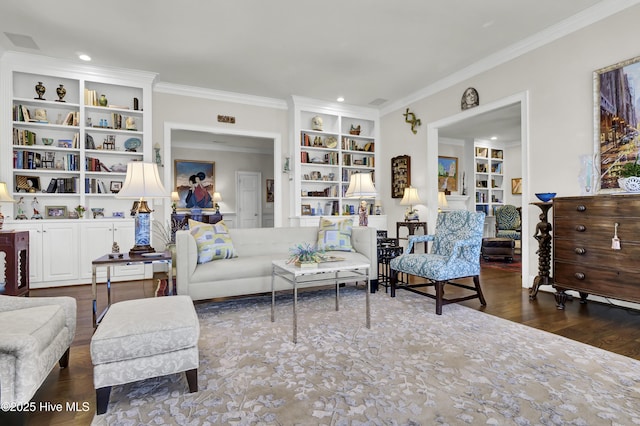 living room featuring dark wood-type flooring, crown molding, and built in features