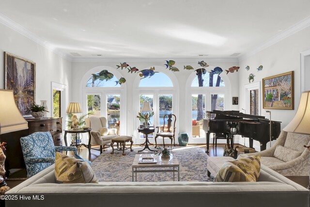 living room with crown molding, wood-type flooring, and a notable chandelier