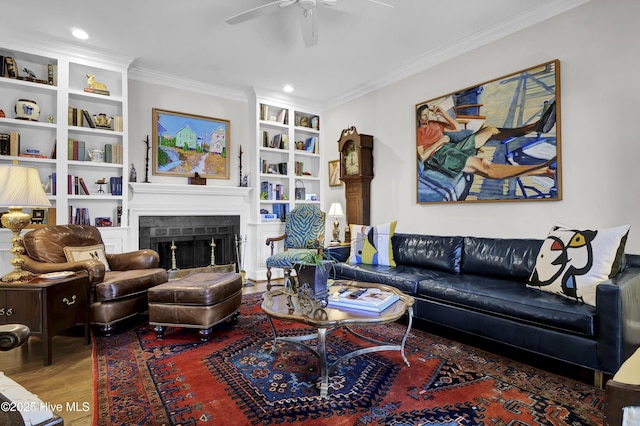 living room featuring ceiling fan, crown molding, built in shelves, and hardwood / wood-style flooring