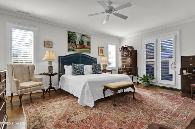 bedroom with crown molding, ceiling fan, dark hardwood / wood-style flooring, and access to exterior