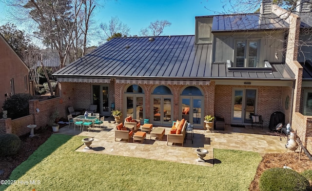 back of house featuring a yard, an outdoor hangout area, french doors, and a patio area