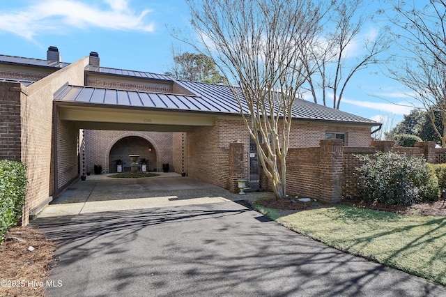 view of side of home featuring a carport and a yard