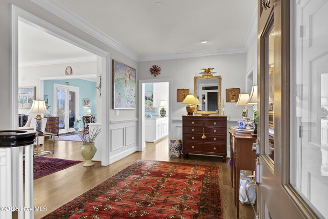 foyer with crown molding and wood-type flooring