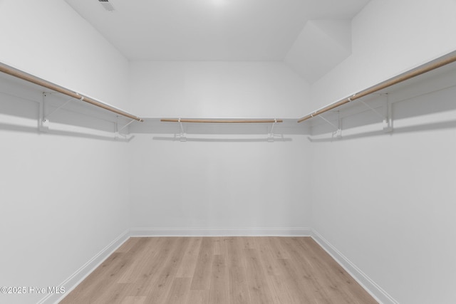 walk in closet featuring light hardwood / wood-style flooring