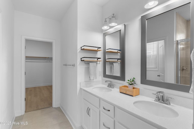 bathroom featuring vanity and an enclosed shower