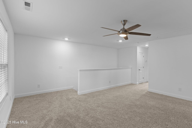 carpeted empty room featuring ceiling fan