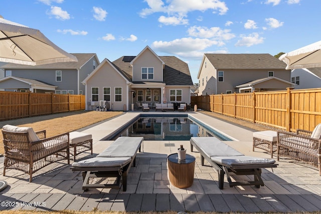 view of pool with an outdoor living space and a patio area