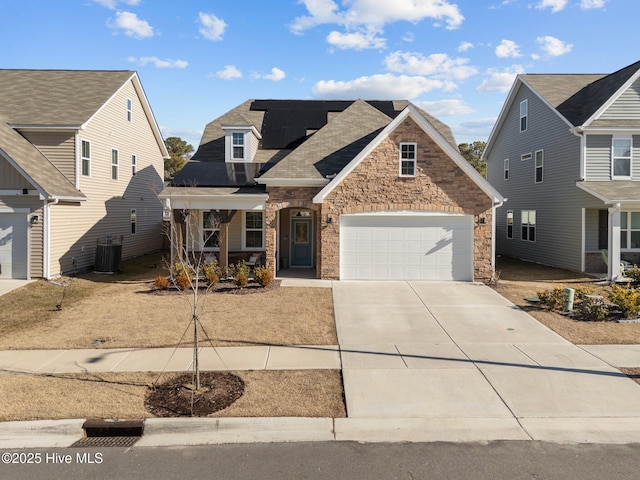 view of front of home featuring a porch, a garage, and cooling unit