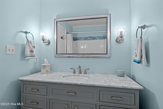 bathroom with vanity, crown molding, and a shower with curtain