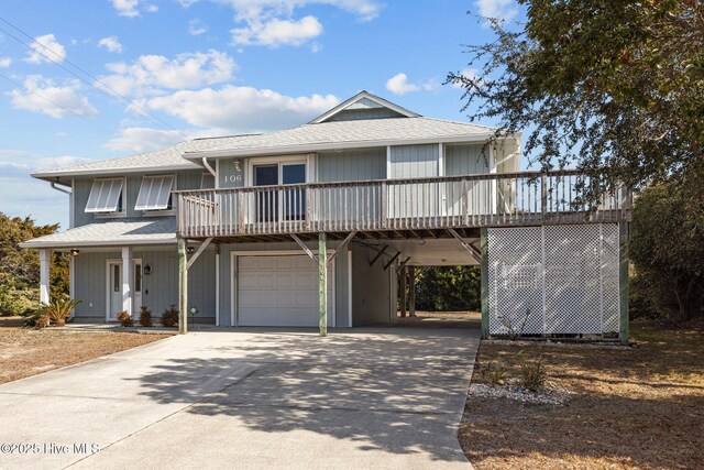 view of front of home with a carport and a garage