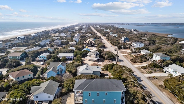 birds eye view of property with a water view and a view of the beach