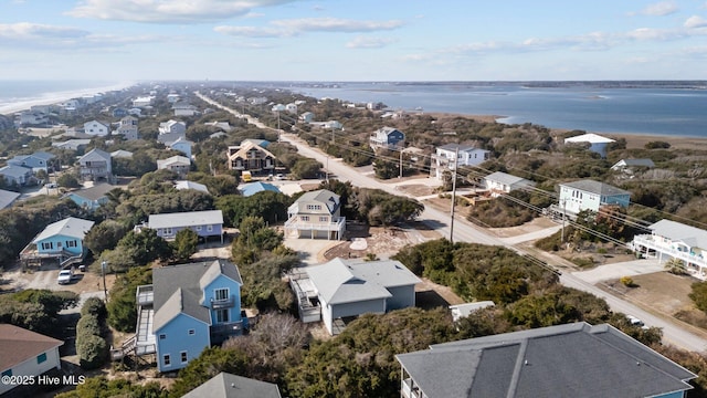 drone / aerial view with a beach view and a water view