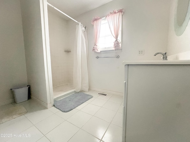 bathroom featuring curtained shower and tile patterned flooring