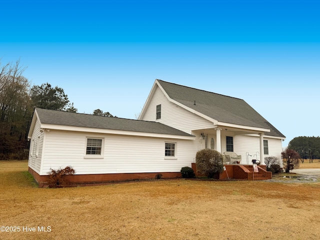 rear view of house with a yard and covered porch