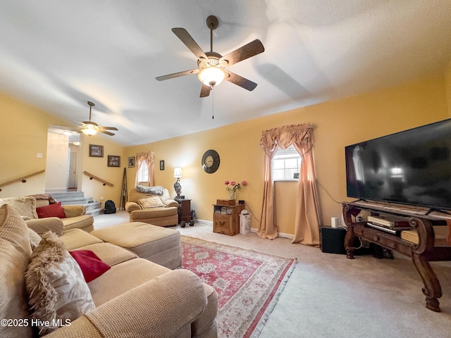 living room featuring ceiling fan, lofted ceiling, and light carpet