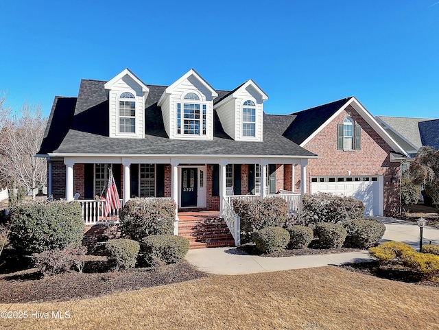 new england style home with a porch and a garage