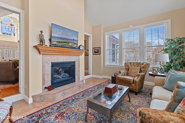 tiled living room with high vaulted ceiling and a high end fireplace