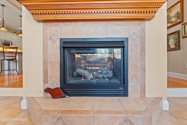 interior details featuring a tiled fireplace