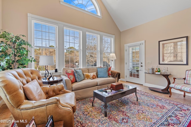 living room featuring tile patterned floors and high vaulted ceiling