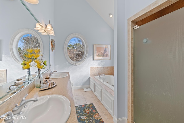 bathroom featuring tile patterned flooring, vanity, lofted ceiling, and independent shower and bath