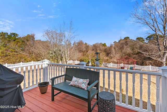 wooden deck with a gazebo and grilling area