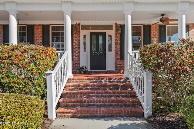 entrance to property featuring covered porch and ceiling fan