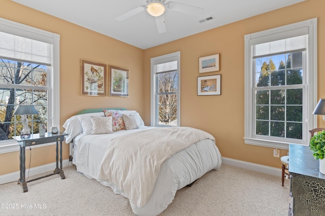 bedroom with multiple windows, carpet flooring, and ceiling fan