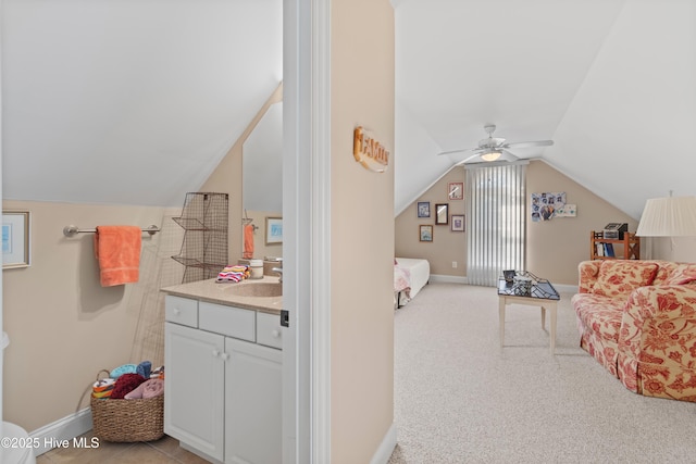 bathroom with ceiling fan, lofted ceiling, and vanity