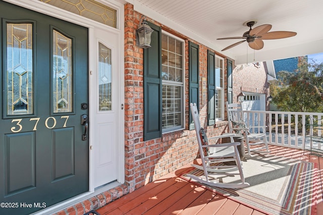 entrance to property featuring ceiling fan and covered porch