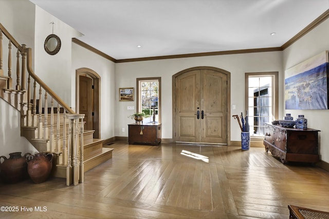 entryway featuring hardwood / wood-style flooring and ornamental molding