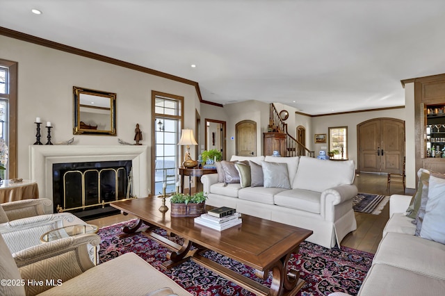 living room featuring crown molding and light hardwood / wood-style floors