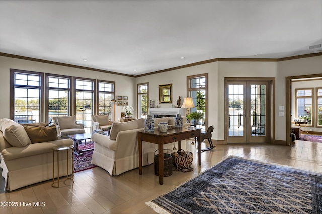 living room featuring french doors, crown molding, and hardwood / wood-style floors