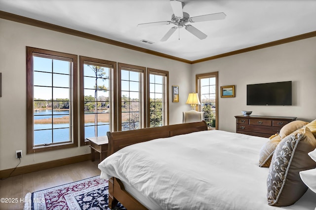 bedroom featuring ornamental molding, hardwood / wood-style floors, and ceiling fan