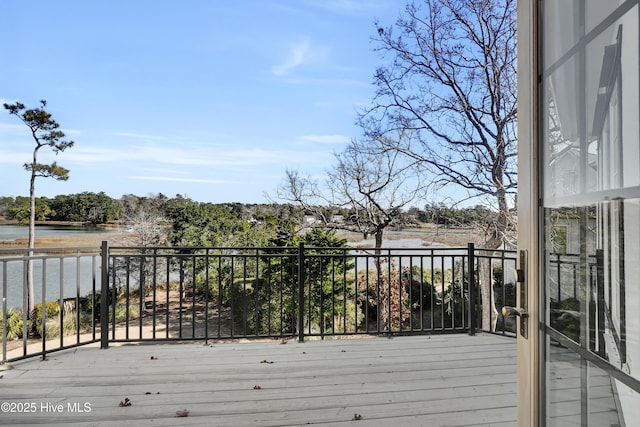 wooden deck with a water view