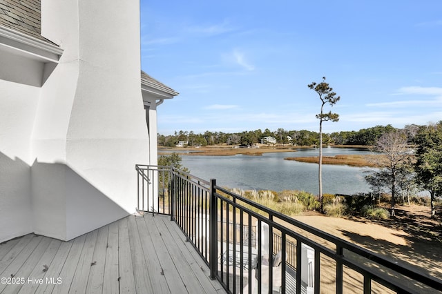 wooden terrace featuring a water view