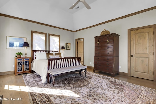 bedroom featuring ceiling fan, a towering ceiling, and light hardwood / wood-style flooring