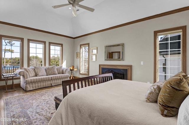 bedroom featuring hardwood / wood-style floors, vaulted ceiling, and ceiling fan