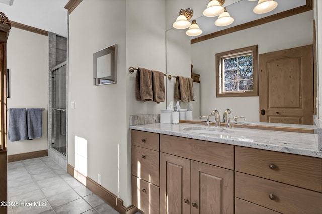 bathroom with ornamental molding, vanity, a shower with door, and tile patterned flooring