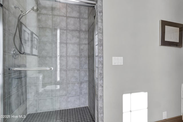 bathroom featuring a shower with door