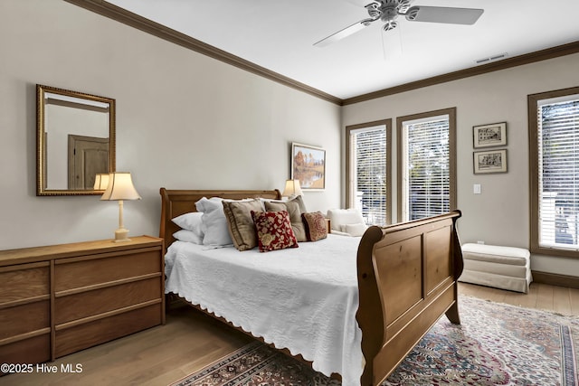 bedroom featuring crown molding, ceiling fan, and light hardwood / wood-style floors