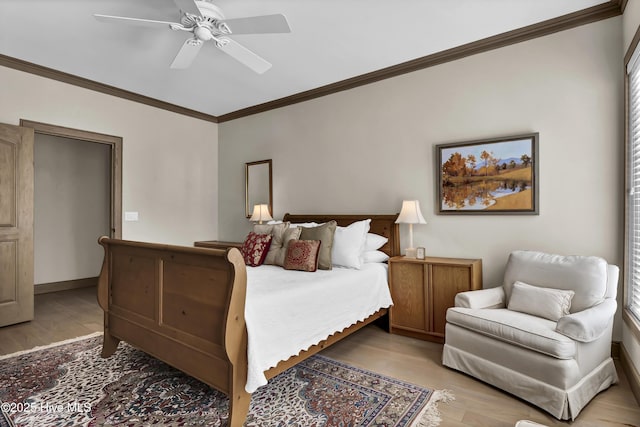 bedroom featuring ornamental molding, ceiling fan, and light wood-type flooring