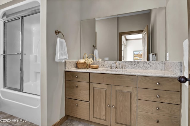 bathroom featuring vanity and enclosed tub / shower combo