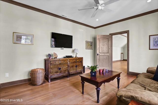 living room featuring ornamental molding, hardwood / wood-style floors, and ceiling fan